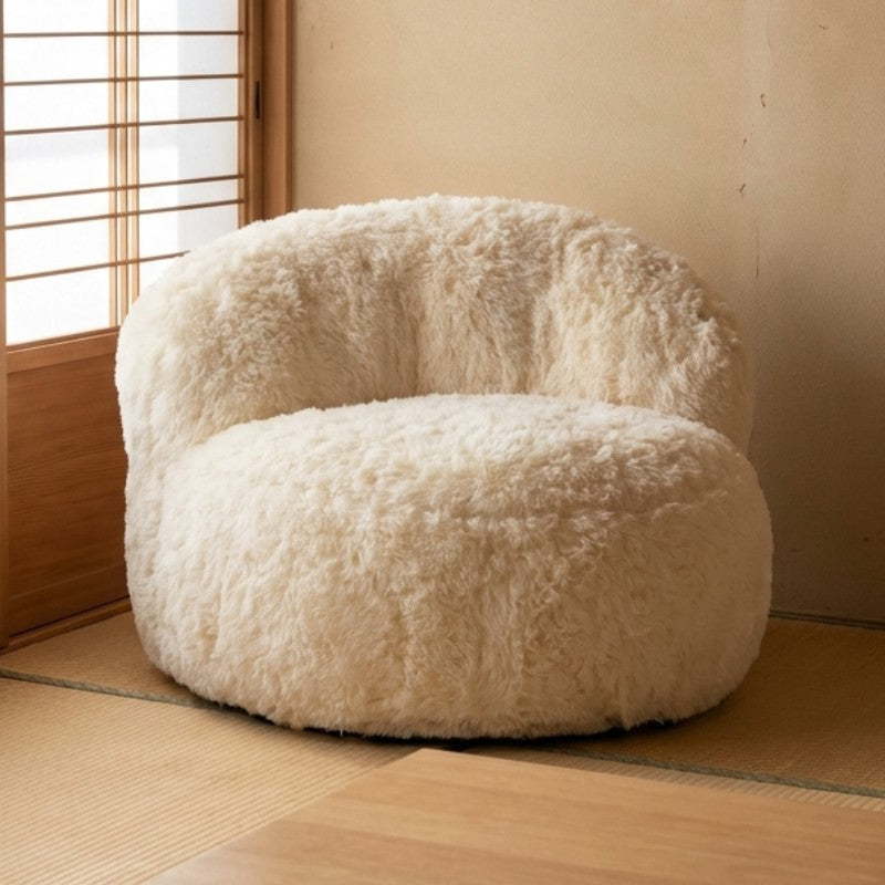 Japanese low sofa armchair with fluffy sherpa fabric on tatami floor near shoji screen in traditional minimalist room