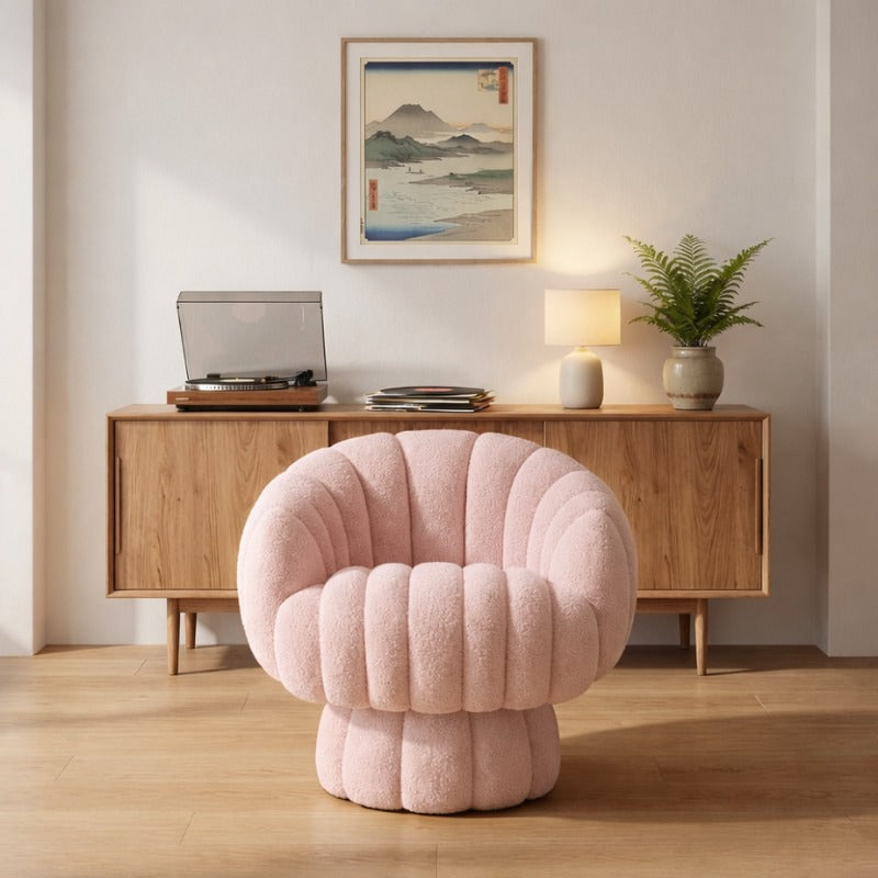 Rounded japanese modern sofa pink bouclé armchair facing wooden sideboard with record player and framed Hiroshige print in warm contemporary Japanese living room