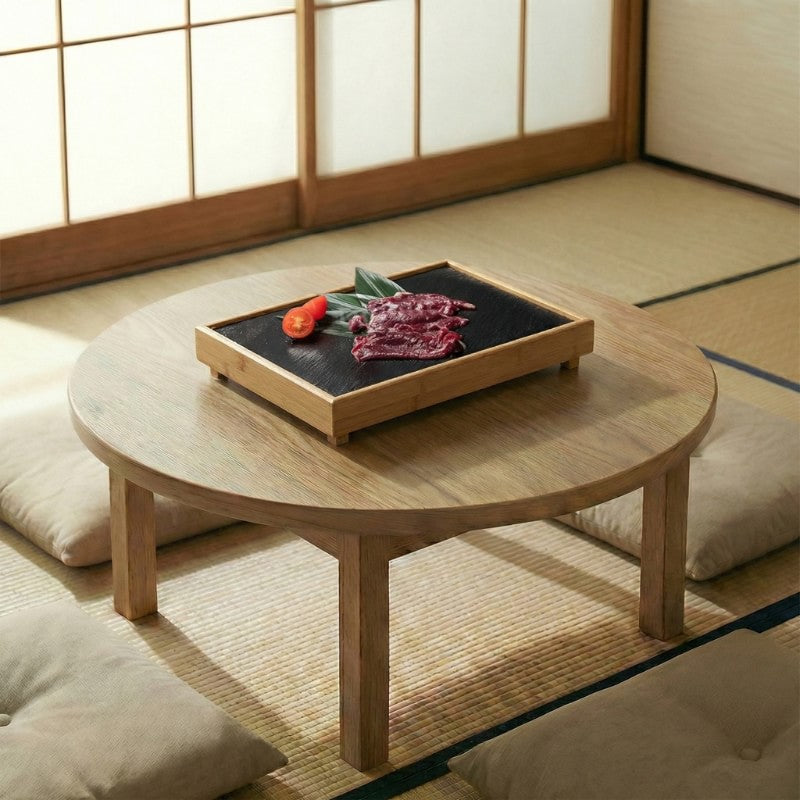 Japanese plate BBQ black slate stone in bamboo tray with raw meat and tomato on round table in traditional tatami room