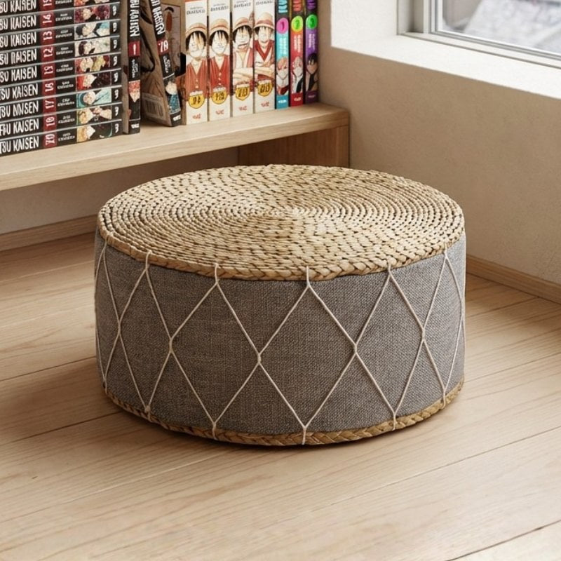 Japanese seat cushion with handwoven rattan and grey diamond pattern linen beside manga bookshelf on wooden flooring