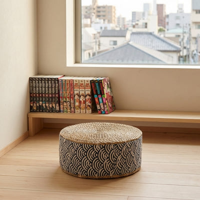 Japanese seat floor cushion with wave pattern on wooden flooring near window with urban neighborhood manga collection