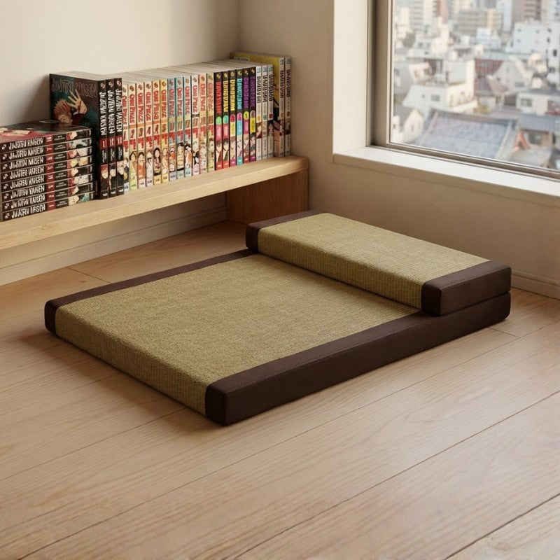 Japanese seating cushion with backrest in beige tatami weave near window with urban view and manga collection shelf