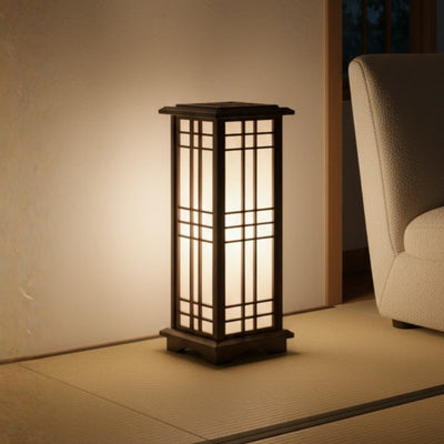 Glowing japanese shoji lamp illuminating tatami floor with warm ambient light creating peaceful evening atmosphere near modern seating