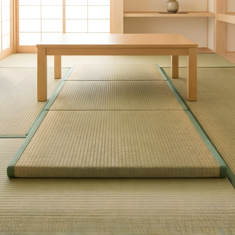 Japanese tatami mat flooring with green brocade borders under wooden chabudai table in authentic room with shoji screen and tokonoma
