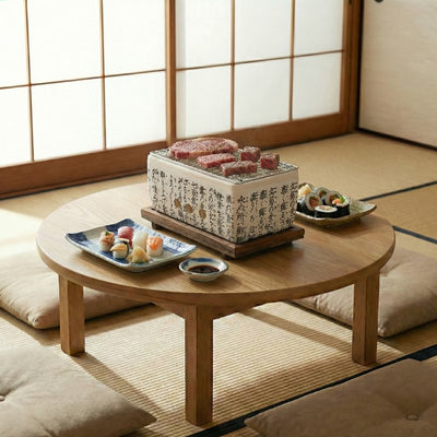 Japanese white barbecue ceramic cooker with calligraphy grilling marbled beef alongside sushi plates on round table in tatami room