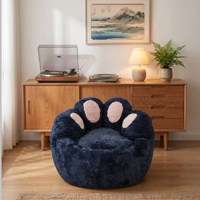 Comfortable kids bean bag chair with a navy blue plush finish and pink paw details in a cozy living room with Japanese wall art.