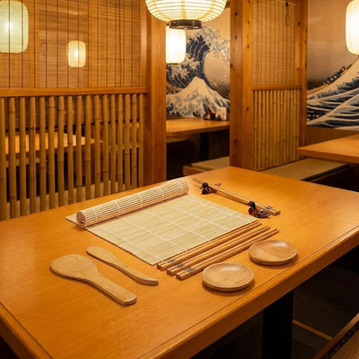 Professional kit sushi maker displayed in Japanese restaurant with iconic Hokusai Great Wave artwork backdrop