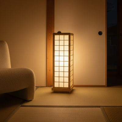 Kumiko lamp casting warm upward light in corner of traditional Japanese room with tatami floor at night