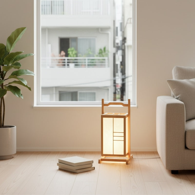 Elegant lamp bamboo with natural wood frame and paper panels glowing softly on wooden floor near bright window in contemporary Japanese style room