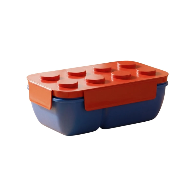 Distinctive lego bento box japanese with raised brick studs and color blocking design on clean white studio background