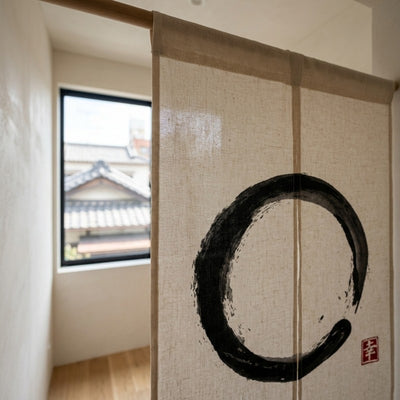Linen curtain noren with black Enso circle close up near window overlooking traditional Japanese rooftops