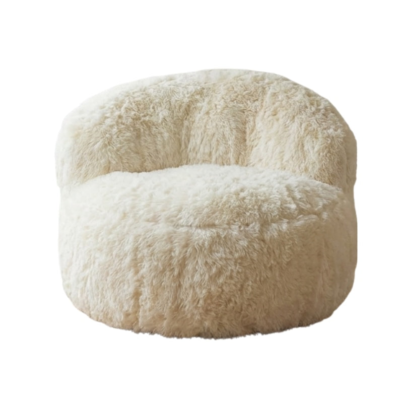 Low sofa japanese armchair with cream fluffy sherpa fabric and curved silhouette isolated on neutral background