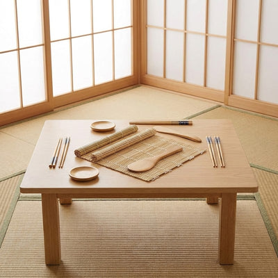 Essential making sushi kit for home use arranged on natural wood chabudai table in traditional Japanese interior