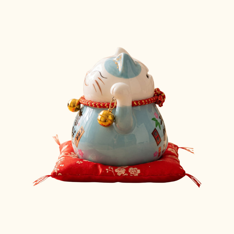 Blue Maneki Neko Lucky Cat Japanese figurine, side view with golden bells and traditional floral details