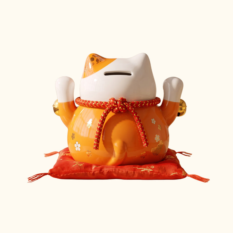 Orange Maneki Neko Lucky Japanese ceramic money box, rear view with raised paws and red cushion