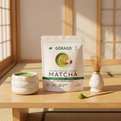Japanese matcha powder by GOKAGO displayed with a ceramic tea bowl, bamboo whisk and scoop in a sunlit tatami room.