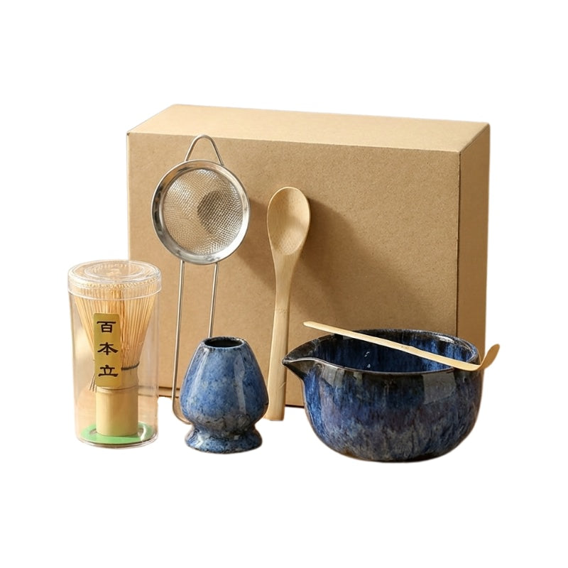 Six-piece matcha whisk japanese set blue featuring ceramic bowl with bamboo accessories and metal sieve on clean white background