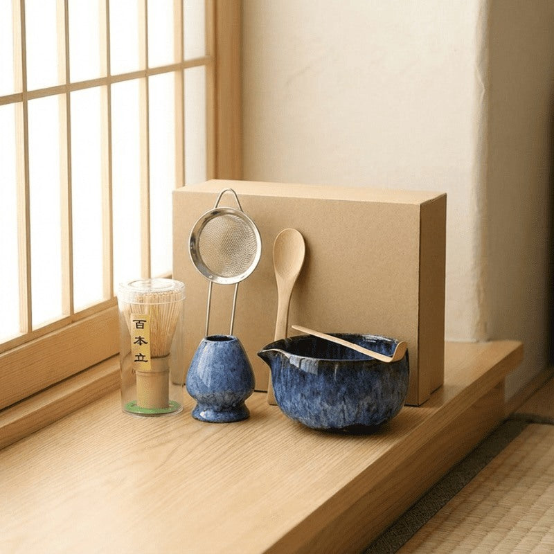 Authentic matcha whisk set japanese blue style in navy glaze positioned on wooden windowsill catching warm natural sunlight