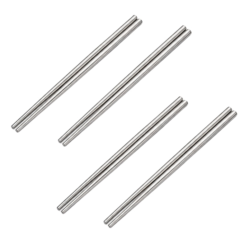 Four pairs of stainless steel metal chopsticks arranged in two crossed sets on white background