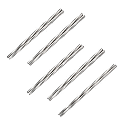 Six pairs of shiny metal chopsticks in stainless steel displayed in a scattered arrangement on white background