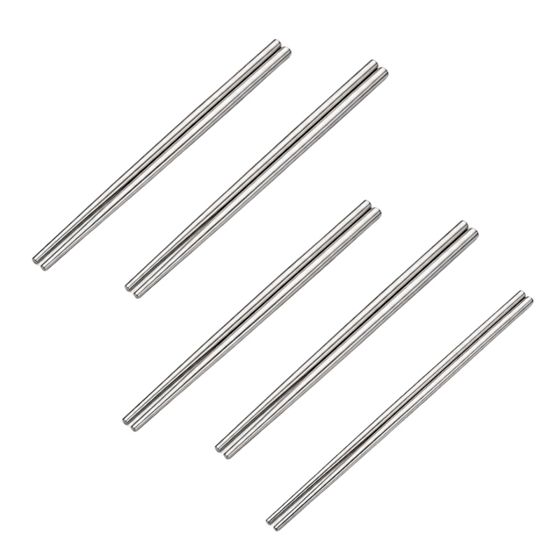 Six pairs of shiny metal chopsticks in stainless steel displayed in a scattered arrangement on white background
