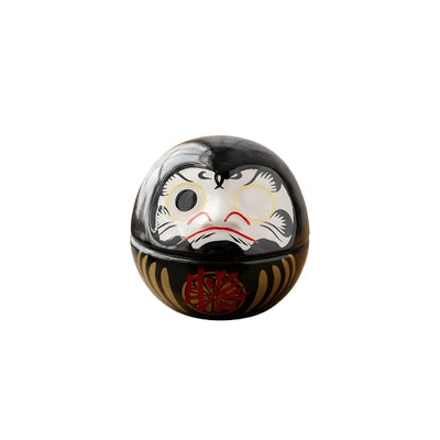 Mini daruma black featuring glossy finish and traditional facial features with prosperity kanji on clean white background
