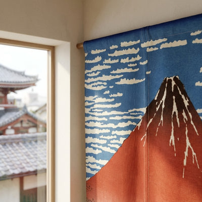 Noren curtain volcano Red Fuji close up near window overlooking traditional Japanese temple rooftops