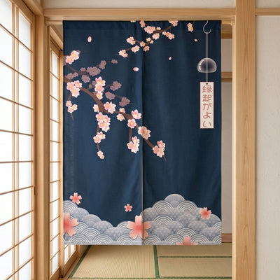 Traditional noren curtain with navy sakura blossoms falling petals glass furin wind chime and seigaiha wave pattern hanging in authentic tatami room doorway with light wood shoji screen panels