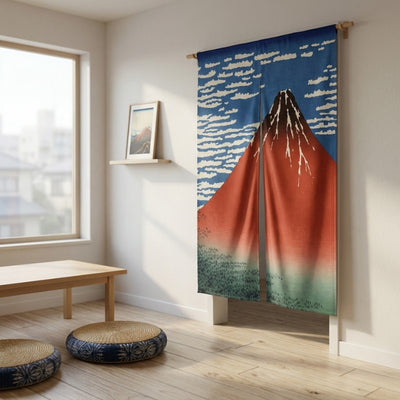 Noren doorway curtain volcano Red Fuji displayed on wall in minimalist Japanese room with low table and woven floor cushions