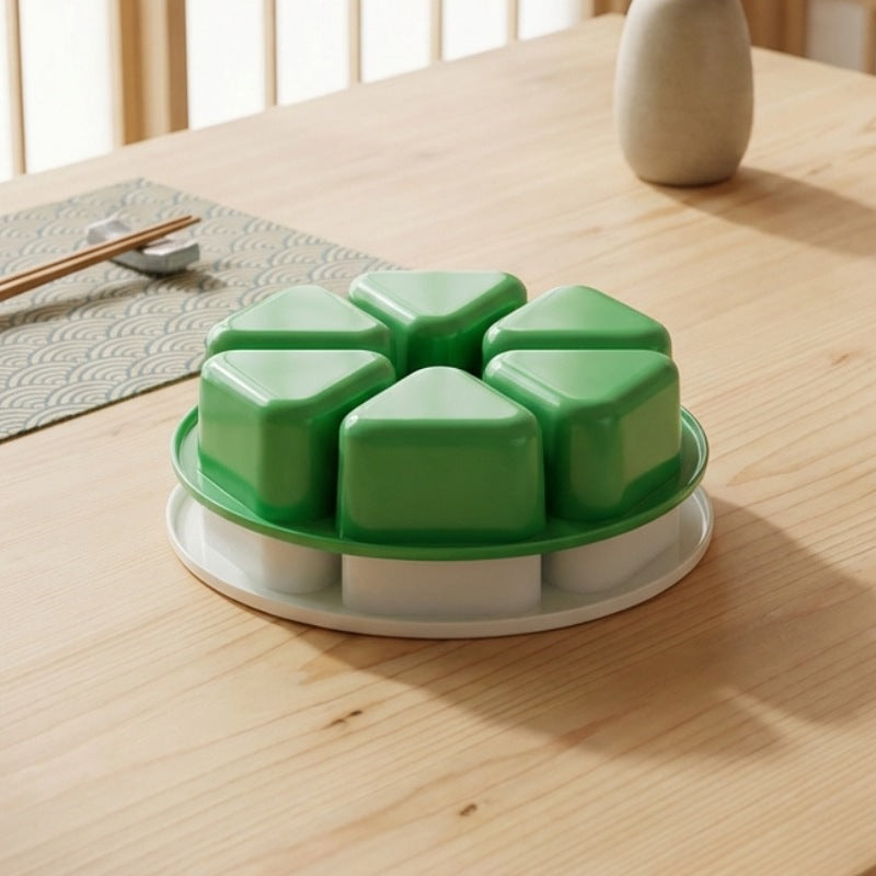 Triangle-shaped onigiri kit mold in green plastic with six compartments for making Japanese rice balls