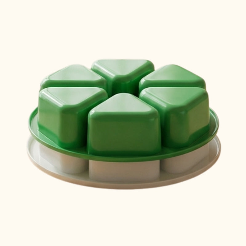 Modern onigiri rice kit featuring green triangular molds on circular base displayed on minimalist table