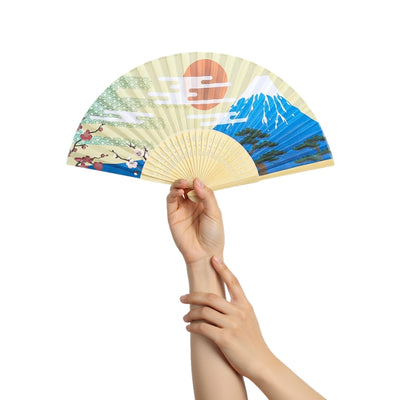 Authentic paper japanese fan with Mount Fuji red sun and cherry blossoms held delicately with both hands against minimalist white background