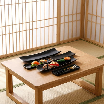 Contemporary plate black for sushi set with multiple pieces displayed on chabudai table in tatami room