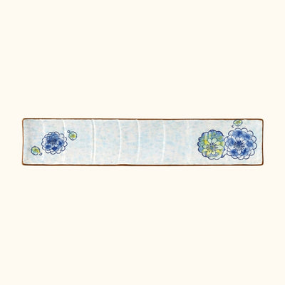 Traditional plate ceramic sushi featuring delicate floral patterns in blue and yellow tones with brown rim edges