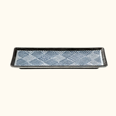 Traditional plate decoration sushi with diagonal line patterns and raised black rim on clean white surface