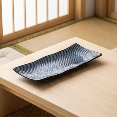 Traditional plate of sushi displayed on chabudai low table in authentic Japanese tatami room with shoji screens