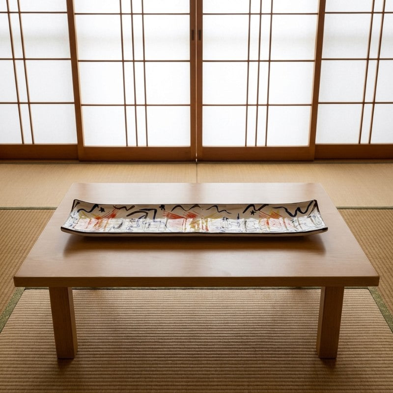 Artistic plate set sushi with colorful abstract waves and traditional Japanese calligraphy motifs on chabudai table