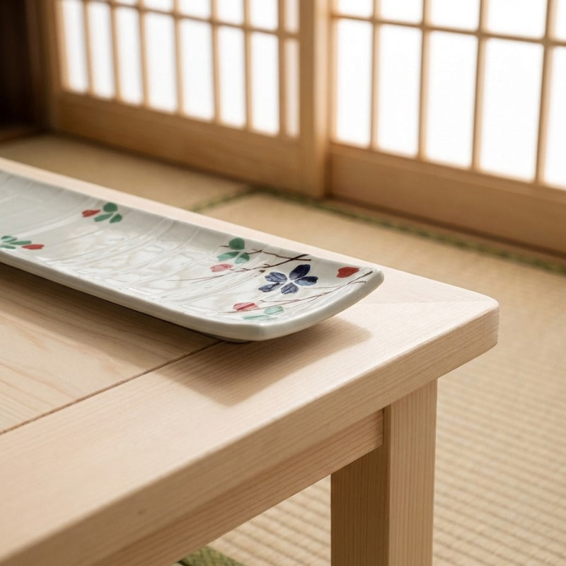 Artisan ceramic plate sushi japanese featuring delicate cherry blossom and clover decorations in natural light