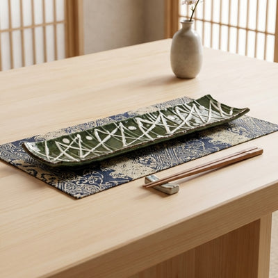 Modern plate sushi zigzag with geometric white pattern on deep green ceramic glaze and indigo table runner