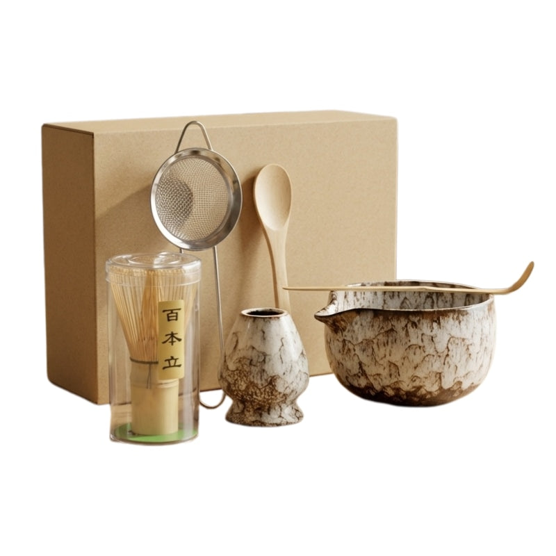 Complete set for matcha japanese with brown speckled ceramic bowl and six bamboo tools on clean white studio background