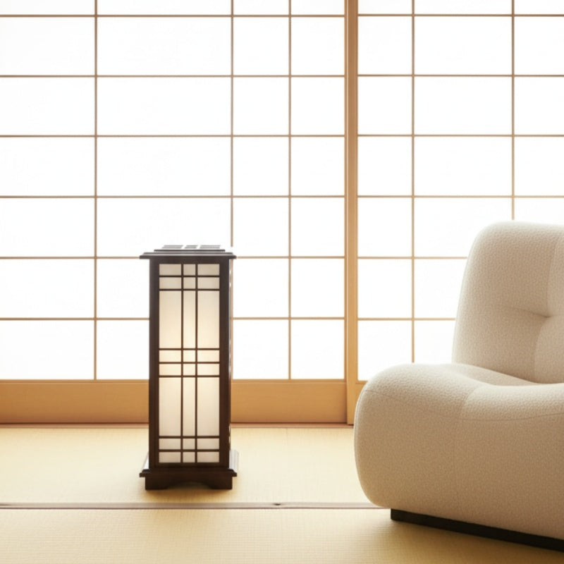 Authentic shoji japanese lamp positioned on tatami mat floor against traditional sliding screens in serene Japanese interior setting