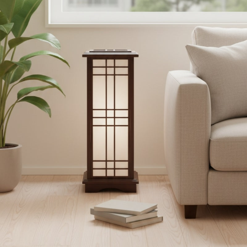 Elegant shoji lamp japanese with dark wood finish standing on wooden floor near cream sofa and tropical plant in contemporary living room