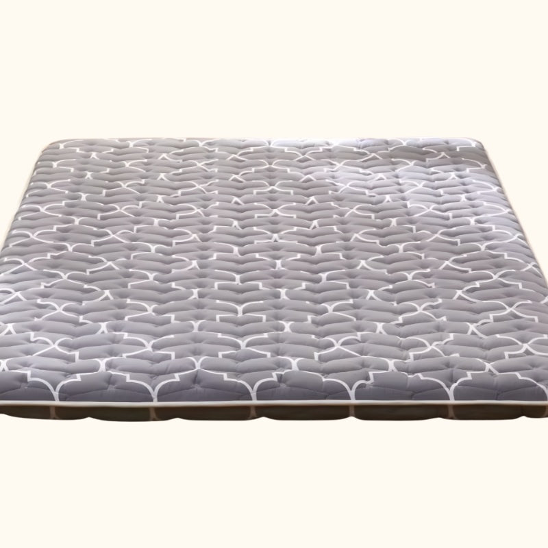 Queen futon size mattress with grey quilted surface and white wave pattern stitching on white background