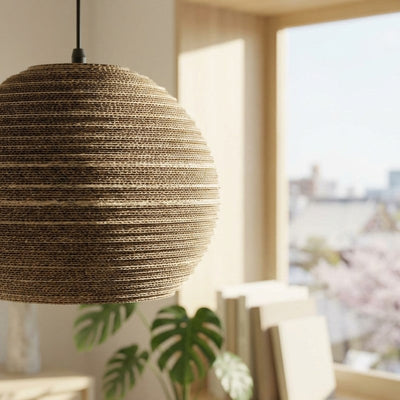 Style Japanese pendant light spherical cardboard detail in natural lighting near window with monstera leaves and urban view