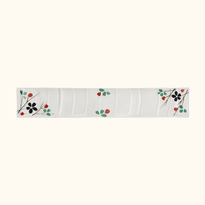 Rectangular white sushi japanese plate with colorful botanical design and flowing wave patterns on clean background