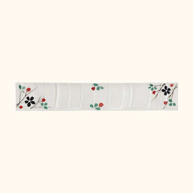 Rectangular white sushi japanese plate with colorful botanical design and flowing wave patterns on clean background