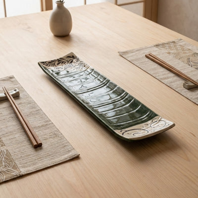 Handcrafted sushi plate flower design on natural wood table with chopsticks and traditional Japanese table setting
