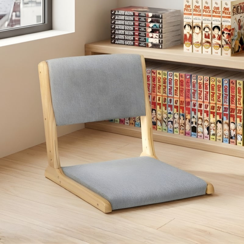 Tatami zaisu chair with gray cushion on light wood flooring near bookshelf with manga collection and window