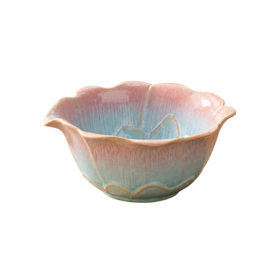 Ceramic tea bowl matcha style with scalloped lotus rim and pink-to-turquoise gradient glaze on white background