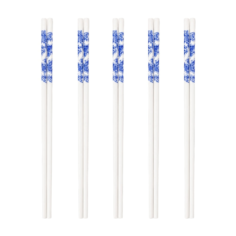 Set of 5 pairs of traditional chopsticks ceramic in white with blue porcelain flower and landscape motif on white background